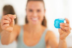 Using dental floss to make your mouth healthy. Billings dentist Cody Haslam shares why.